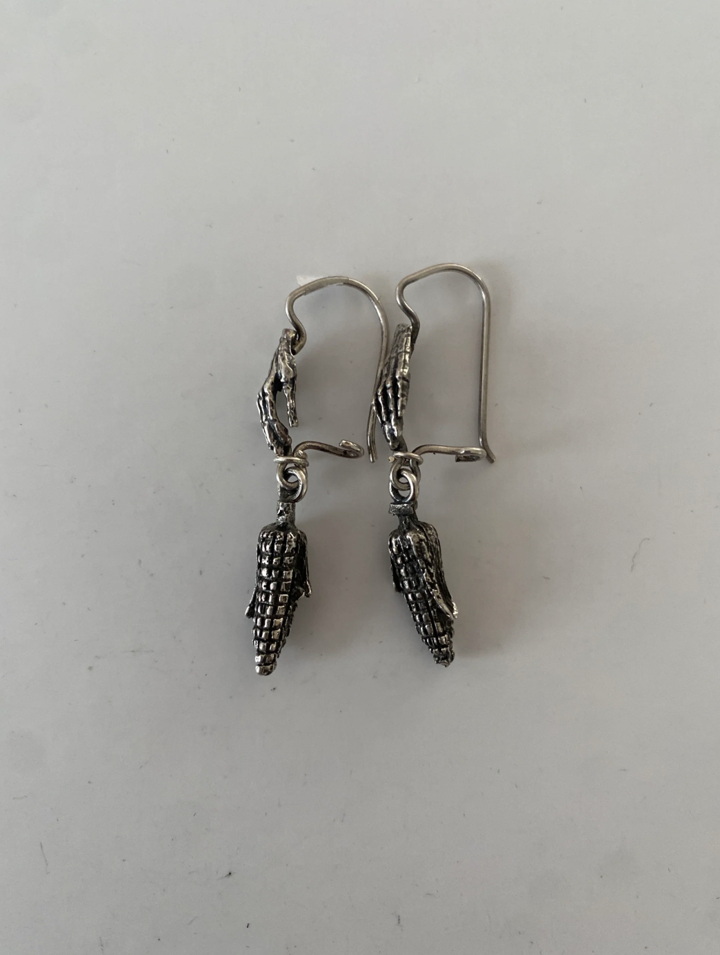 Indómita – Aretes mazorca de maíz con manos de calavera